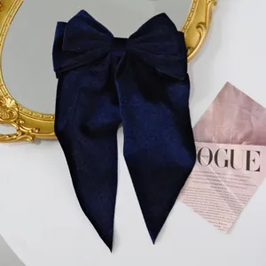 Vintage navy blue velvet large bow hair clip with elegant long streamers in detail