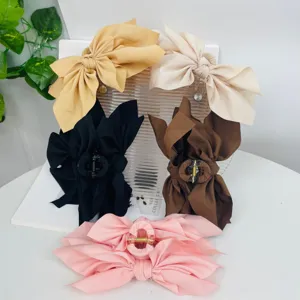 Large fabric bow hair claw clips set in assorted pastel and neutral colors for women
