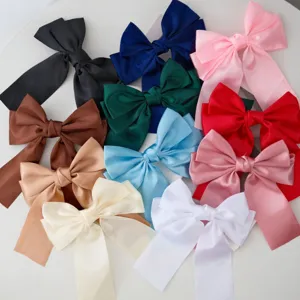 Assorted candy-colored satin ribbon bow hair clips displayed on white background