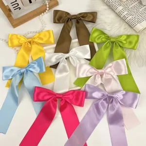 Detailed view of colorful satin bow hair clips with long streamers for sweet hair styles