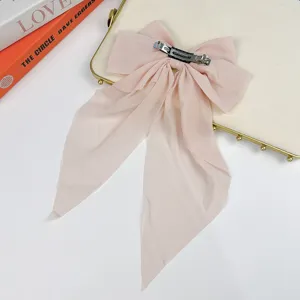 Detailed back view of a large pink chiffon ribbon bow hair clip with an elegant spring clip