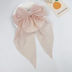 Elegant large pale pink chiffon bow hair clip with long flowing streamers for women