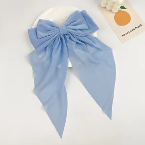 Detailed view of the elegant light blue chiffon bow hair clip with long streamers