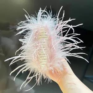 Detailed view of an elegant fluffy pink ostrich feather hair claw clip accessory.