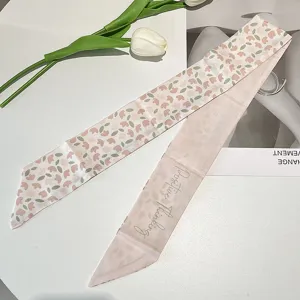 Detail of vintage French floral silk ribbon for hair with Positive Thinking script