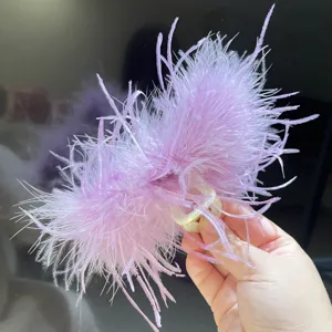 Detail view of the soft light purple ostrich feathers on a large hair claw clip base.