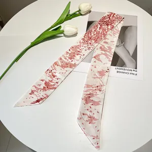 Detailed view of vintage French style silk ribbon scarf with elegant red landscape print