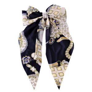Elegant large bow hair clip with long ribbons and sophisticated baroque chain print.