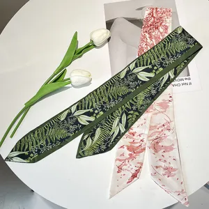Detailed view of French vintage green botanical and red floral printed skinny silk scarves