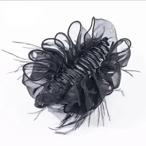 Close-up view of elegant black feather and organza mesh ruffled large hair claw clip