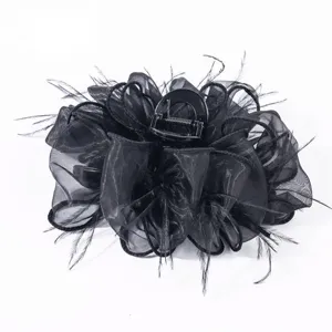 Detailed view of the black mesh and feather texture on this elegant puffy cloud hair claw clip.