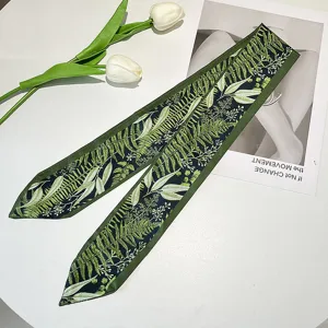Close-up detail of retro French green floral leaf print skinny scarf hair ribbon