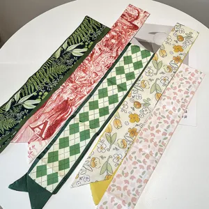 Detailed view of vintage French silk hair ribbons with floral and checkered prints.