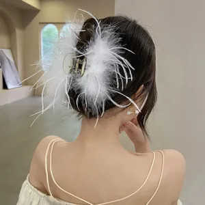 Detailed view of an elegant large white ostrich feather hair claw clip on model's hair