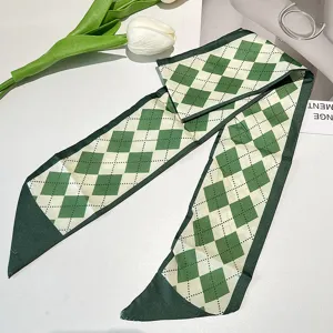 Detailed view of the vintage French green diamond pattern silk-like hair ribbon and scarf.