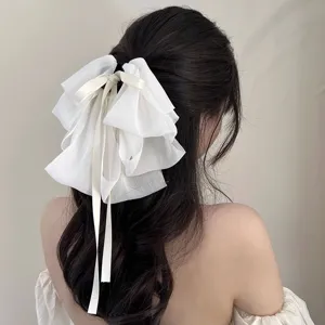 Back view showing the intricate layered chiffon bow design of this white hair clip