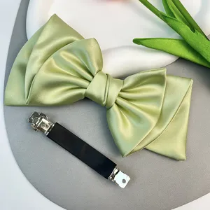 Elegant light green satin bow hair clip with black barrette for women's hair styling