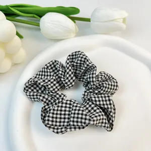Detalle de coletero de algodón a cuadros blancos y negros en un plato blanco