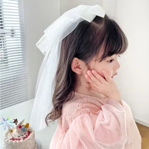 Elegant white mesh bridal veil for girls with large bow detail hair clip.