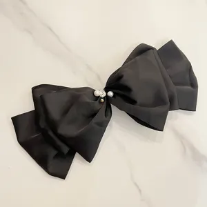 Elegant large black pearlescent satin bow hair clip with pearl and rhinestone details