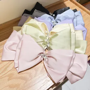 Handmade large French satin bow hair clips with elegant pearls and sparkling rhinestones.