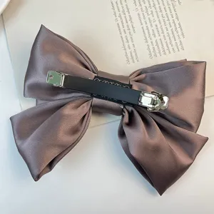 Detailed back view of satin bow hair clip showing the metal spring barrette clip