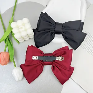 Elegant three-layer satin bow hair clips in black and burgundy with metal clip