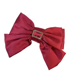 Elegant red satin three-layer bow hair clip with a decorative gold chain buckle charm