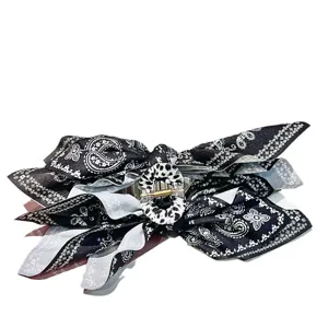 Large black and white paisley print fabric bow hair claw clip with irregular design