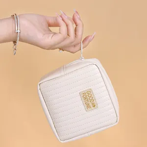 Portable cream-colored waterproof PU storage pouch for sanitary napkins and makeup.