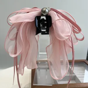 Elegante pinza para el pelo con lazo de gasa rosa, cintas largas y perla metálica