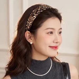Model wearing a retro leopard print mesh wide-edge headband for a high cranial top look