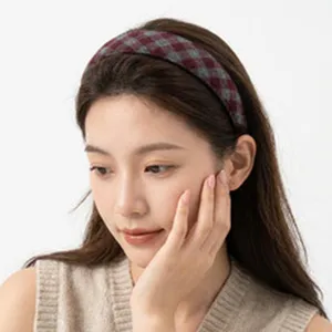 Close-up view of a stylish retro red and grey checkered wide headband worn by an Asian model