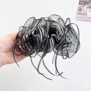 Close-up of elegant black striped organza bow hair claw clip for women's updos