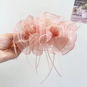 Detailed view of pink striped organza bow hair claw clip with elegant long ribbons