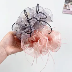 Detailed view of elegant striped organza bow hair claw clips in purple and pink colors