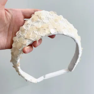 Detailed view of an ivory sequin crown headband with vintage crochet lace textures.