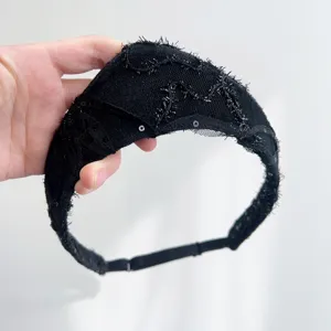 Close-up of a vintage black sequined crown headband with intricate lace detail