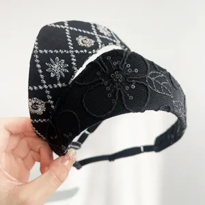 Close-up of vintage black lace and embroidered crown headbands with sequins