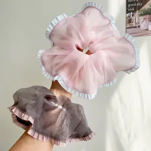 Detailweergave van grote mesh ruches scrunchies met delicate gelaagde randen