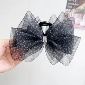 Detalle de la pinza para el cabello con lazo de malla de leopardo y brillantes diamantes