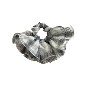 Large black and white plaid scrunchie with elegant ruffled skirt design for hair.