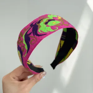 Detailed view of bohemian vintage ethnic style wide fabric headband with embroidery