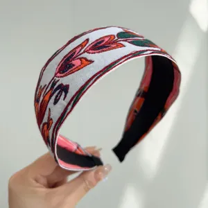 Detailed view of the bohemian style wide fabric headband with colorful ethnic embroidery