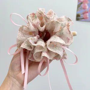 Detailed close-up view of a Mori style floral scrunchie with pink ribbons and rabbit print