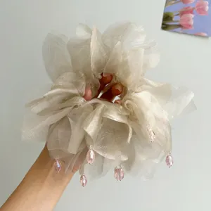 Primo piano di un grande elastico in organza con gocce di cristallo rosa.
