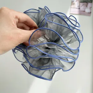 Close-up of blue mesh ruffled hair claw clip showing elegant layered fabric texture