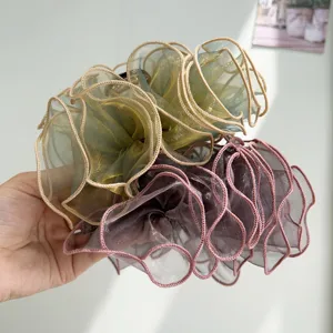 Macro view of layered organza mesh texture on large decorative hair claw clips for women