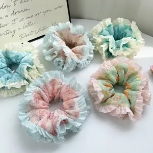 Close-up of pastel ruffle scrunchies with floral and plaid prints