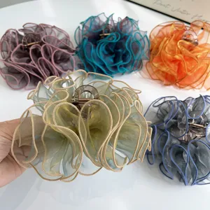 Close-up of elegant organza ruffle hair claw clips in various soft aesthetic colors